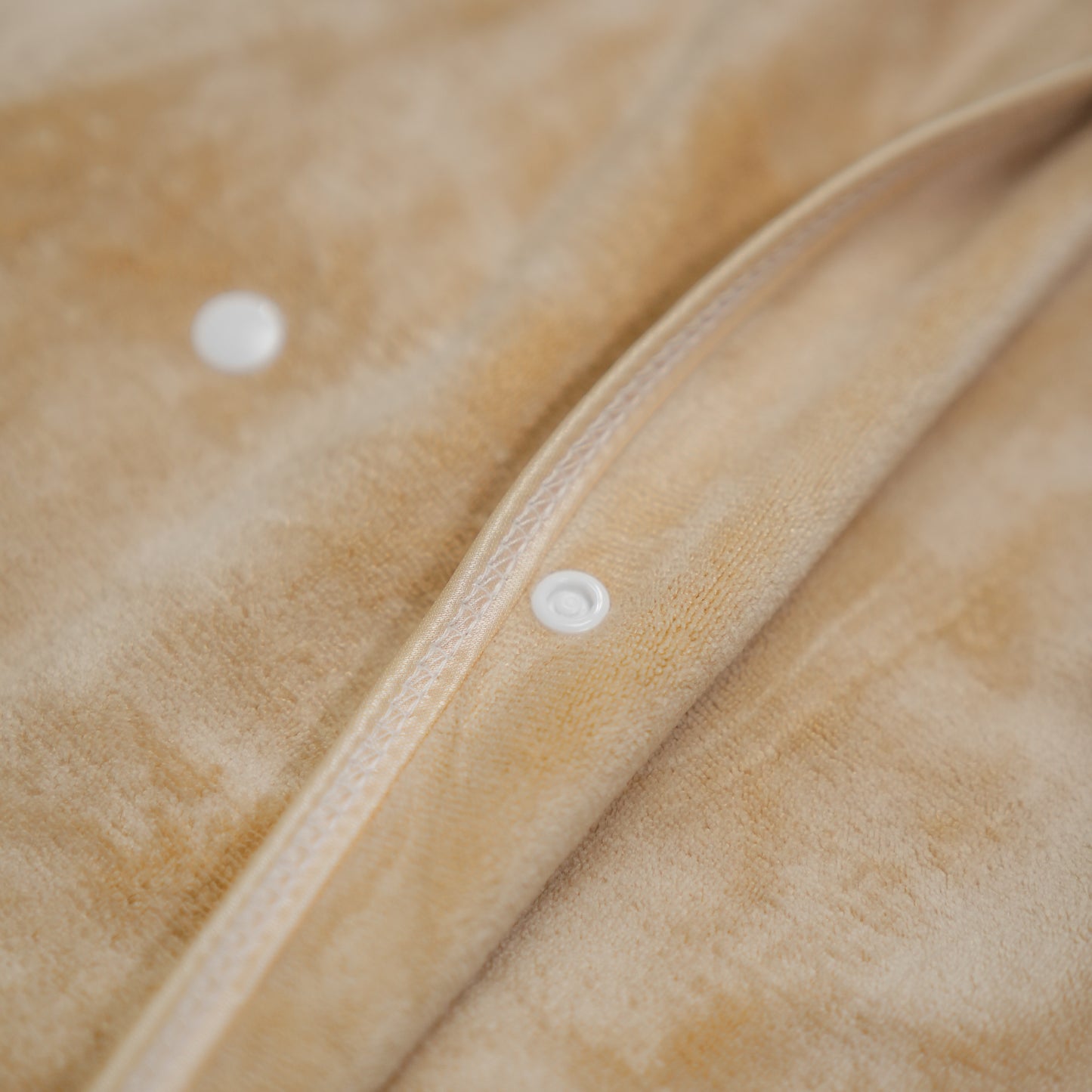 A beige microfiber bath wrap with the ArtĄ brand logo visible on the product.