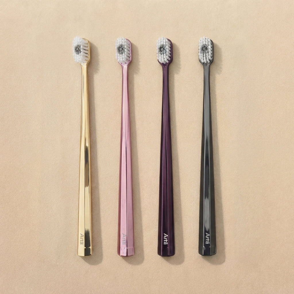 Four toothbrushes in gold, pink, purple, and black on a beige background
Arta soft toothbrush in multiple colors designed for gentle cleaning and daily oral care with comfortable grip and soft bristles.
فرشاة أسنان آرتا الناعمة متوفرة بعدة ألوان، مصممة لتنظيف لطيف وفعال للأسنان مع شعيرات ناعمة ومقبض مريح للاستخدام اليومي.