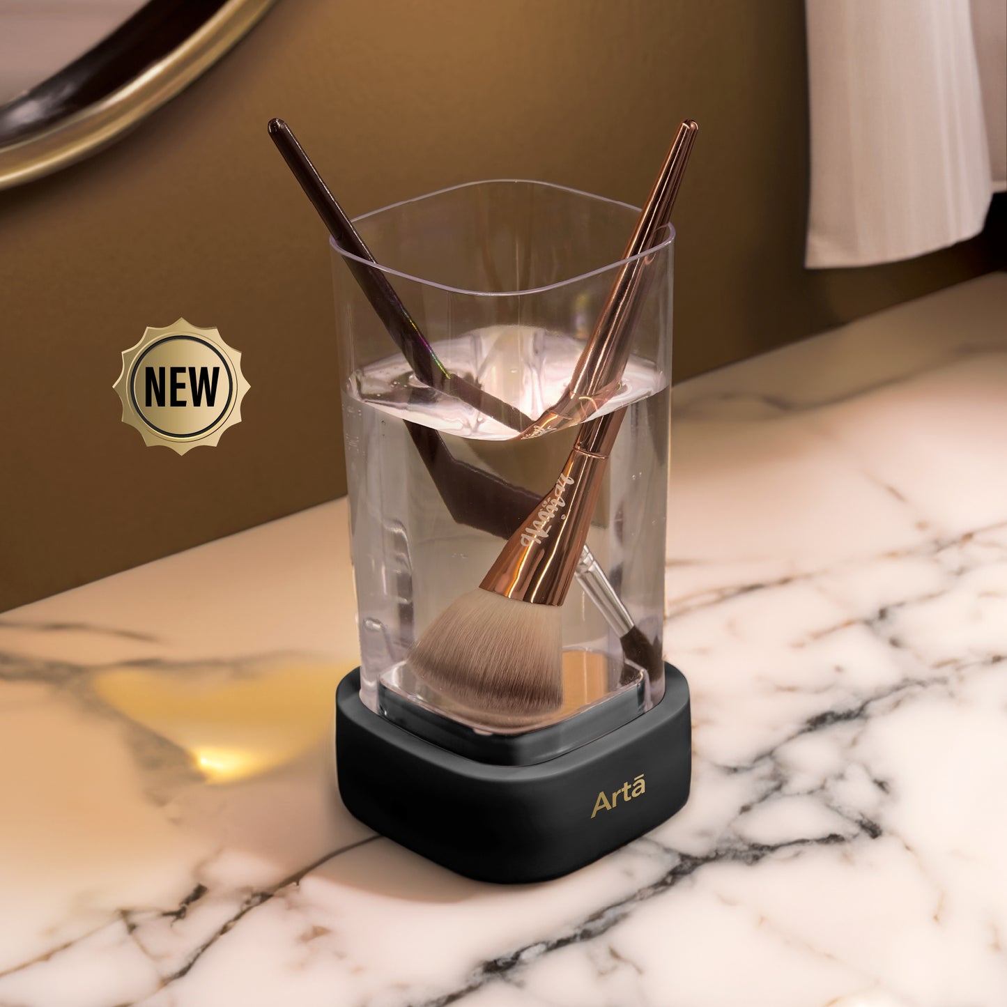 A white ultrasonic cleaner with gold-colored metal objects inside, possibly dental tools, with several clear plastic dental aligners beside it on a countertop.